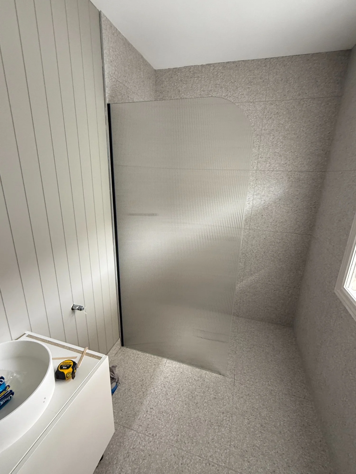 Frameless reeded glass shower screen installation Melbourne
