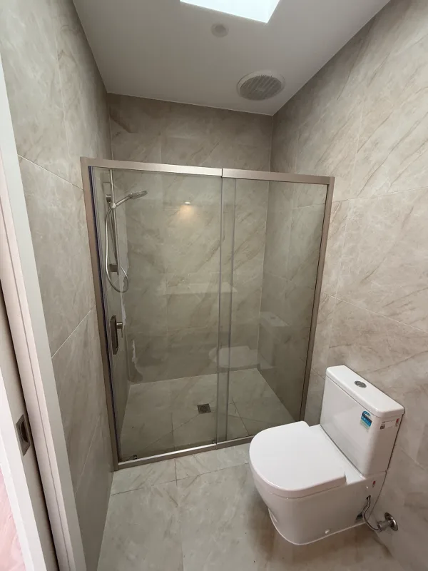 Semi-frameless sliding shower screen with brushed nickel frame