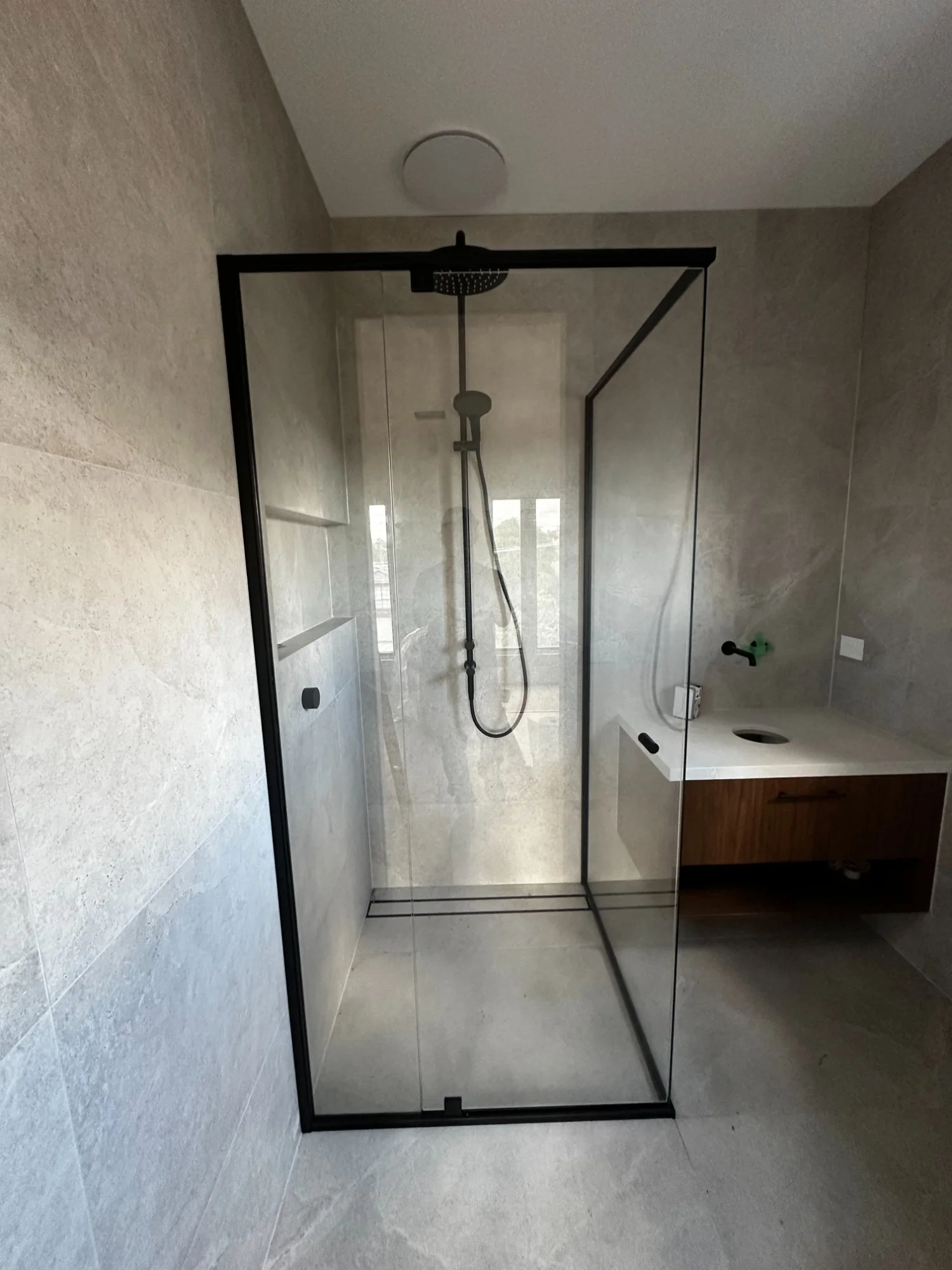 Semi-frameless shower screen matte black hardware Melbourne